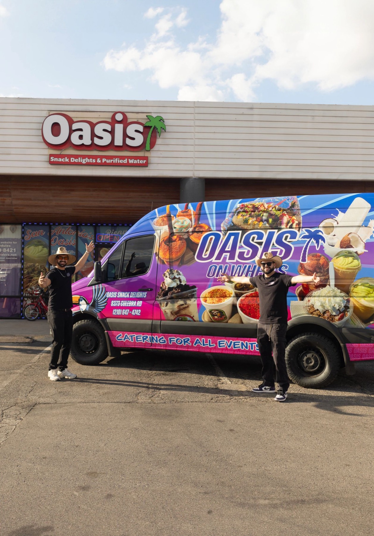 Juan Pablo and Cristobal Flores standing with arms out in front of the Oasis On Wheels van